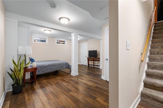 bedroom featuring dark wood-style floors and baseboards