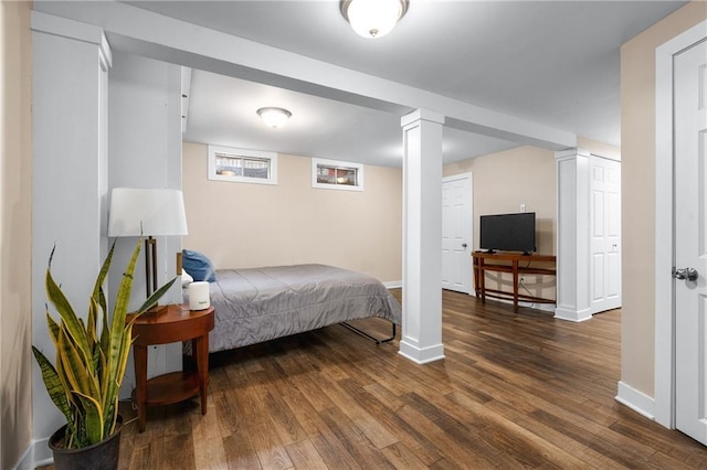 bedroom featuring wood finished floors and baseboards