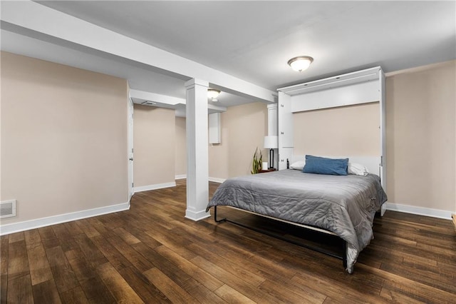 bedroom with visible vents, baseboards, and hardwood / wood-style floors