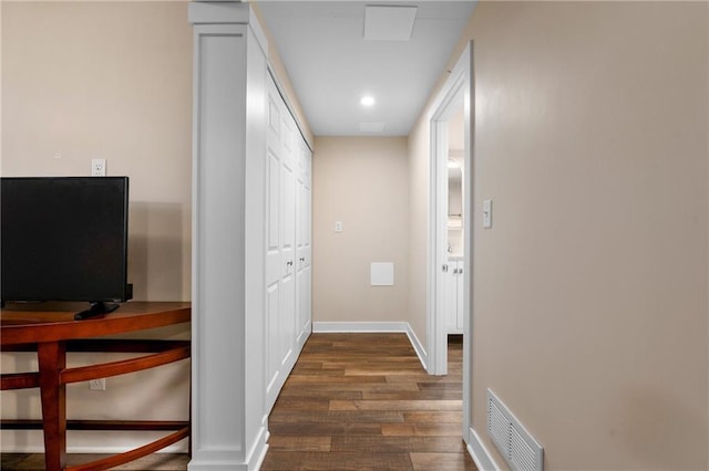 hallway with dark wood-type flooring, recessed lighting, visible vents, and baseboards