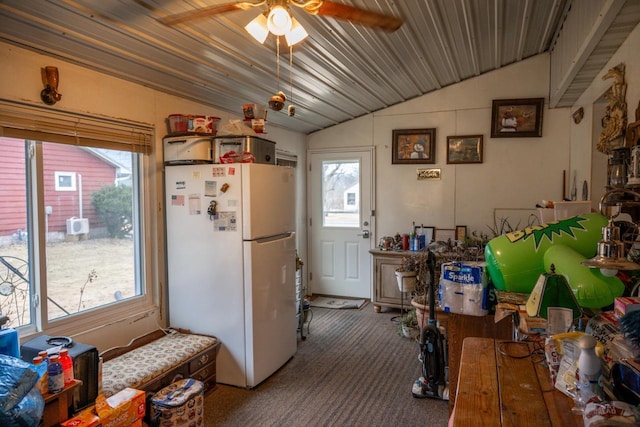 kitchen featuring ceiling fan, carpet, vaulted ceiling, and freestanding refrigerator