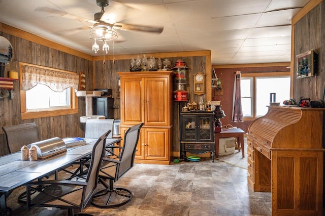 office with ceiling fan, wooden walls, and a wealth of natural light