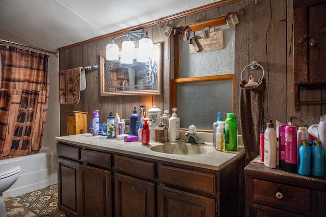 bathroom with toilet, shower / tub combo, wood walls, vanity, and vaulted ceiling