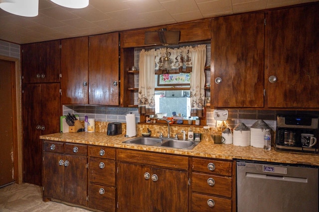 kitchen featuring decorative backsplash, light countertops, dishwasher, and a sink