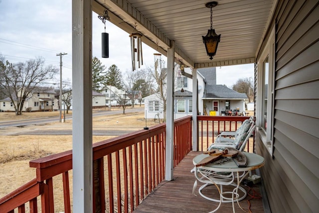 wooden deck with covered porch and a residential view