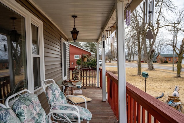 wooden terrace featuring covered porch