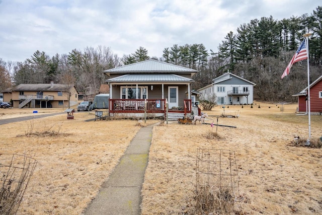 bungalow with metal roof and a porch