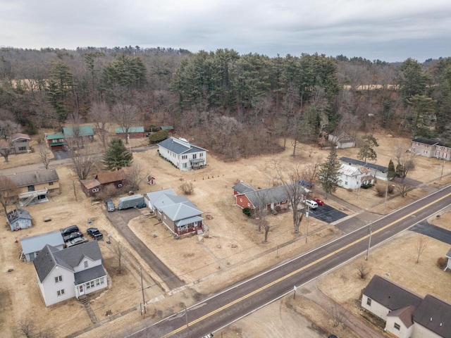 birds eye view of property with a view of trees