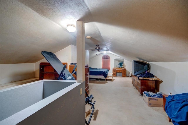 carpeted bedroom with lofted ceiling and a textured ceiling