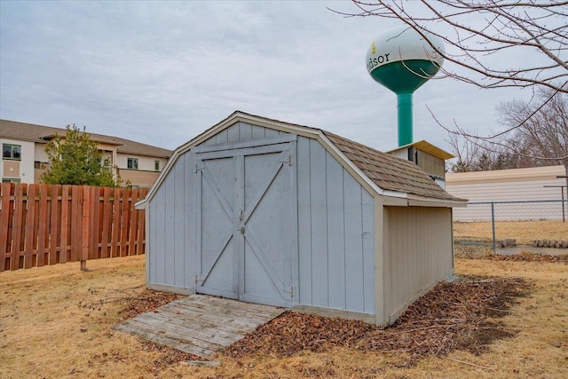 view of shed featuring fence