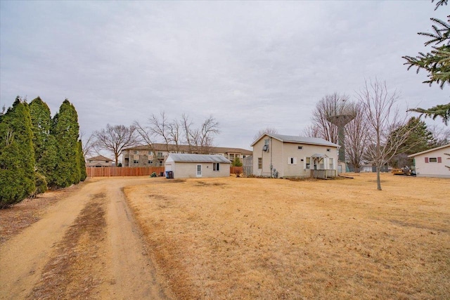 view of front of home featuring driveway and fence