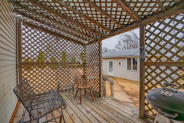 deck featuring grilling area and a pergola