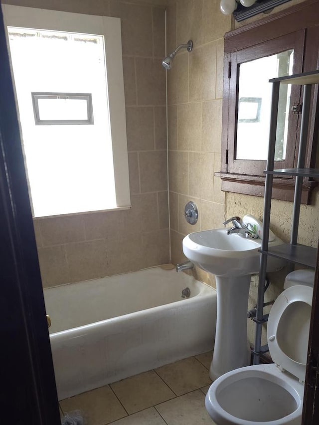 full bath with shower / washtub combination, toilet, and tile patterned floors