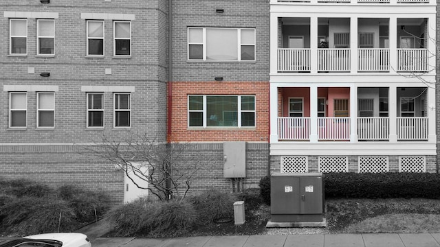 exterior space featuring brick siding and cooling unit