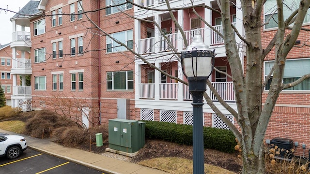 view of building exterior featuring uncovered parking