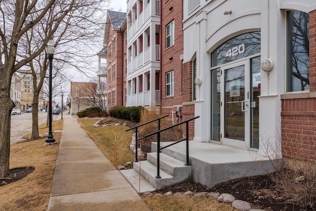 doorway to property with brick siding