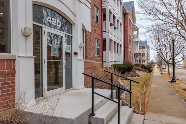 property entrance with brick siding