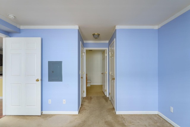 unfurnished bedroom featuring carpet, electric panel, baseboards, and crown molding