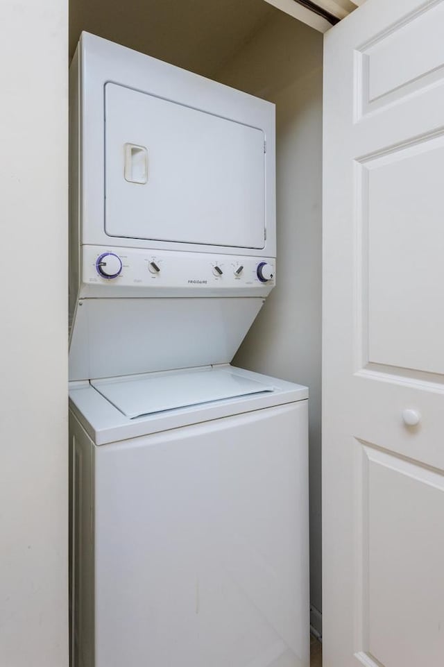 laundry area with stacked washer and dryer and laundry area