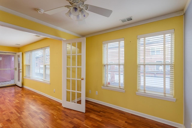 doorway to outside with a wealth of natural light, visible vents, and wood finished floors