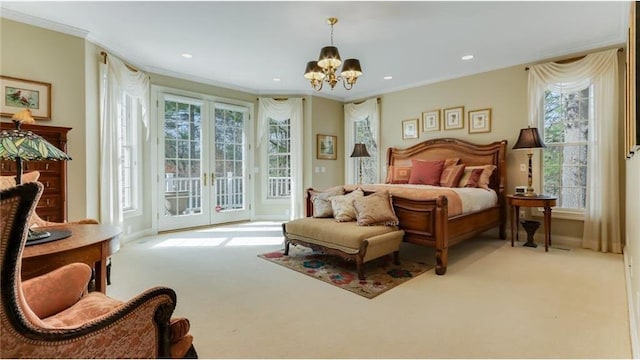 carpeted bedroom featuring an inviting chandelier, access to outside, multiple windows, and french doors