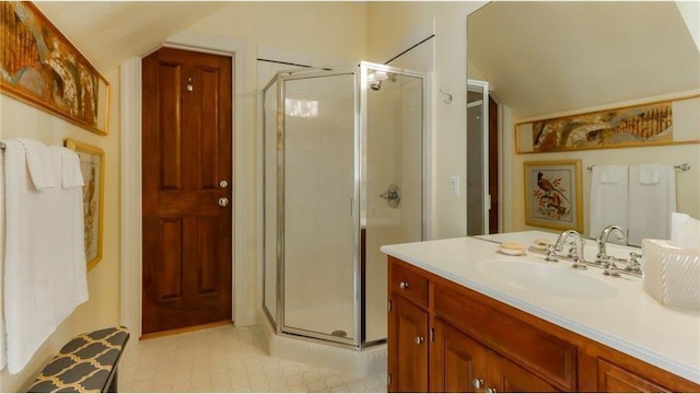 full bath featuring a shower stall, vanity, and vaulted ceiling