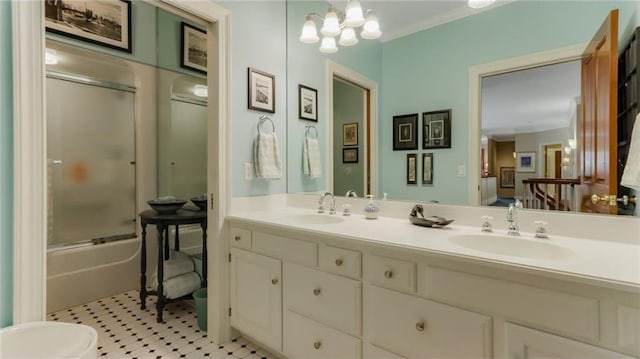 bathroom with double vanity, a chandelier, shower / bath combination with glass door, and a sink