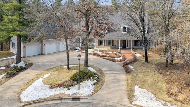 new england style home with a garage and driveway