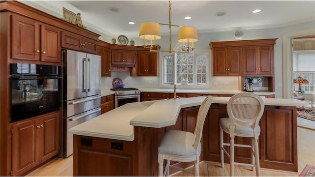 kitchen featuring a wealth of natural light, stainless steel appliances, an island with sink, and light countertops