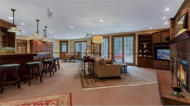 living room featuring recessed lighting, light colored carpet, and a brick fireplace