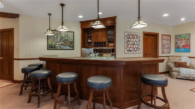 bar featuring indoor wet bar, recessed lighting, light carpet, and decorative light fixtures