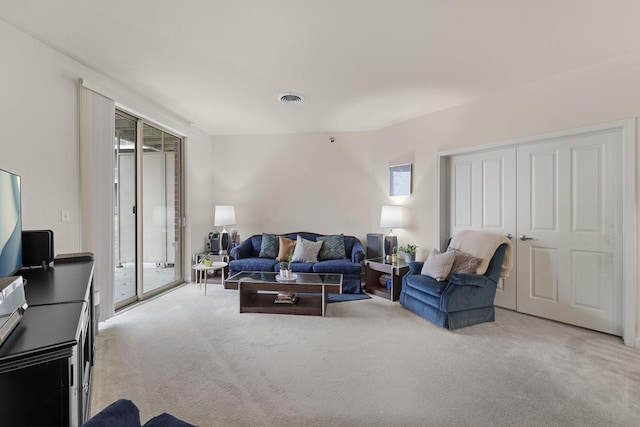 living area with carpet floors and visible vents