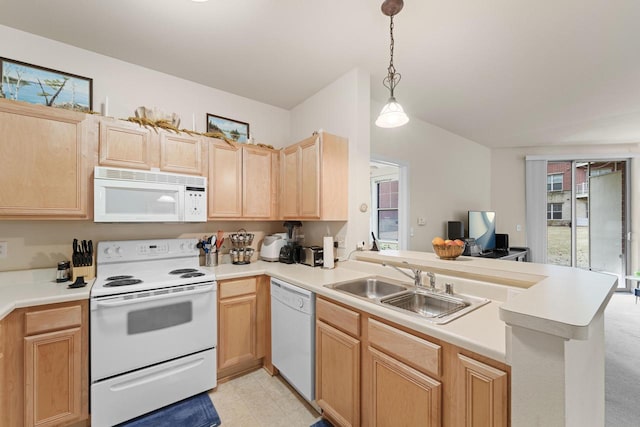 kitchen featuring white appliances, a peninsula, light countertops, light brown cabinetry, and a sink