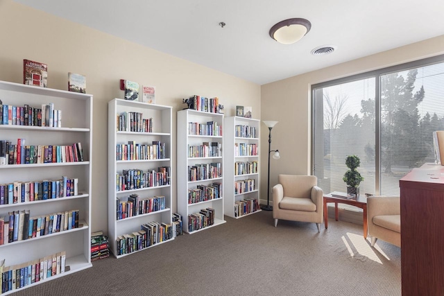 sitting room featuring carpet, visible vents, and a wealth of natural light