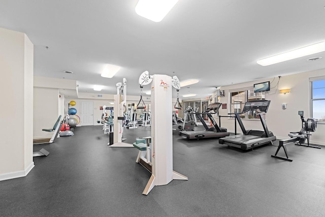 exercise room with visible vents and baseboards