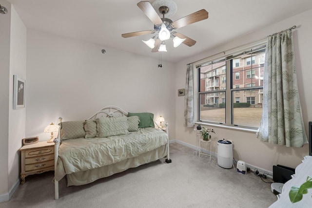 carpeted bedroom featuring ceiling fan and baseboards