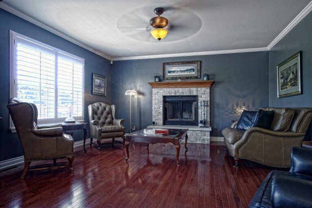 sitting room with hardwood / wood-style flooring, baseboards, a fireplace, and ornamental molding