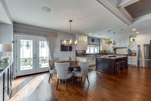 dining area featuring dark wood-style floors, a wealth of natural light, and french doors