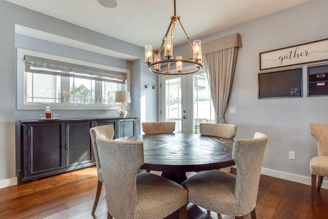 dining room with a healthy amount of sunlight, wood-type flooring, baseboards, and french doors