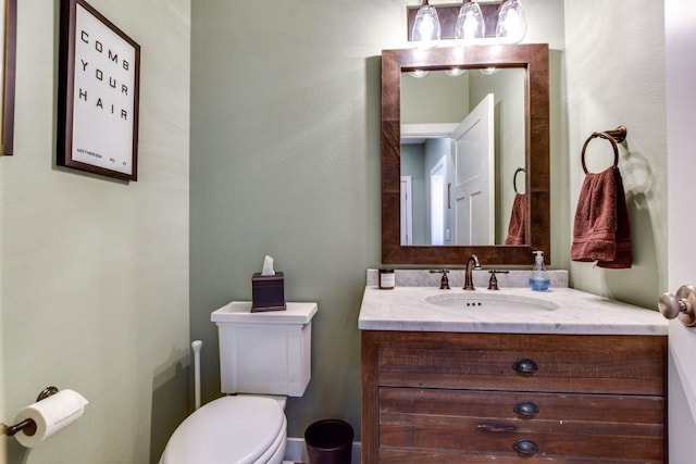 half bathroom with toilet and vanity