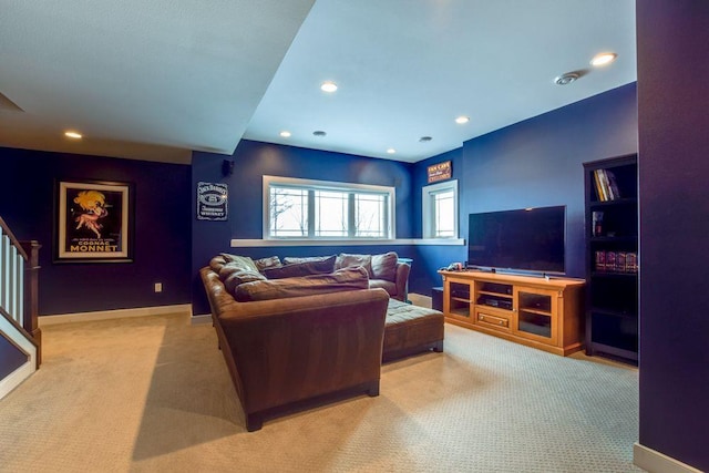 carpeted living area featuring baseboards, stairway, and recessed lighting