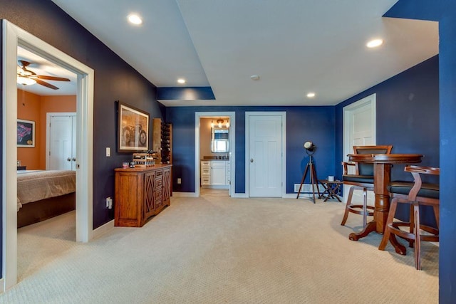 living area featuring light carpet, ceiling fan, baseboards, and recessed lighting