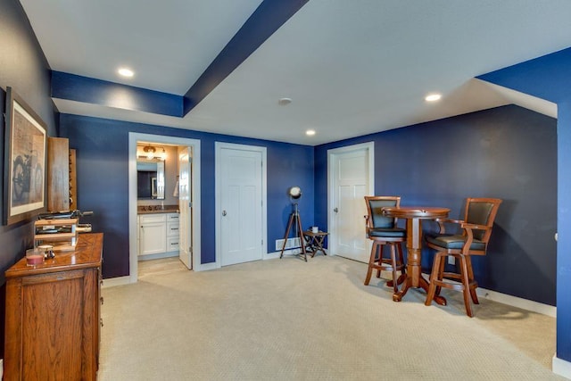 interior space featuring recessed lighting, light carpet, and baseboards