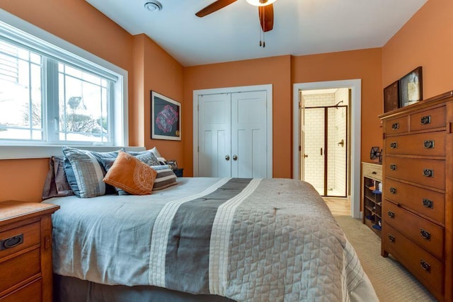 bedroom featuring a closet, light carpet, and ceiling fan