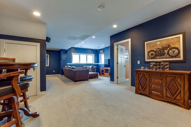 living room with recessed lighting, light colored carpet, and baseboards