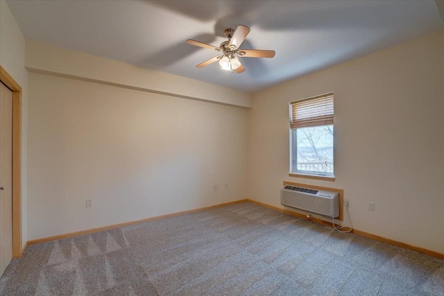 empty room featuring a wall unit AC, ceiling fan, light carpet, and baseboards