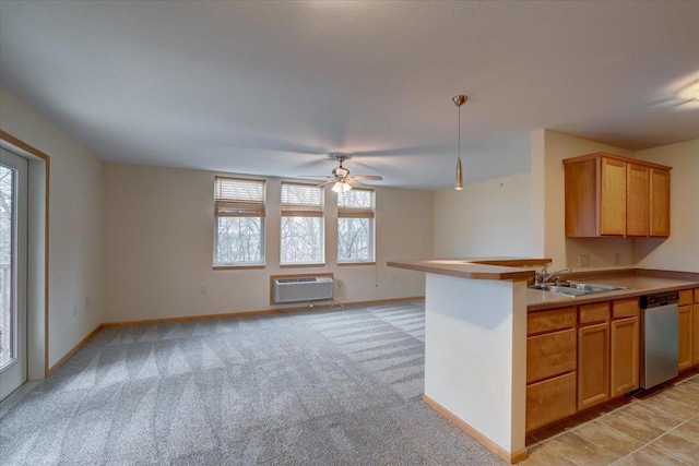 kitchen with light colored carpet, a sink, open floor plan, an AC wall unit, and stainless steel dishwasher