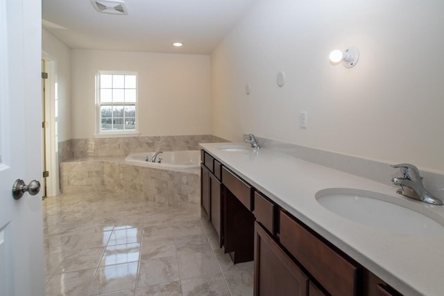 full bathroom with marble finish floor, visible vents, a sink, and a bath