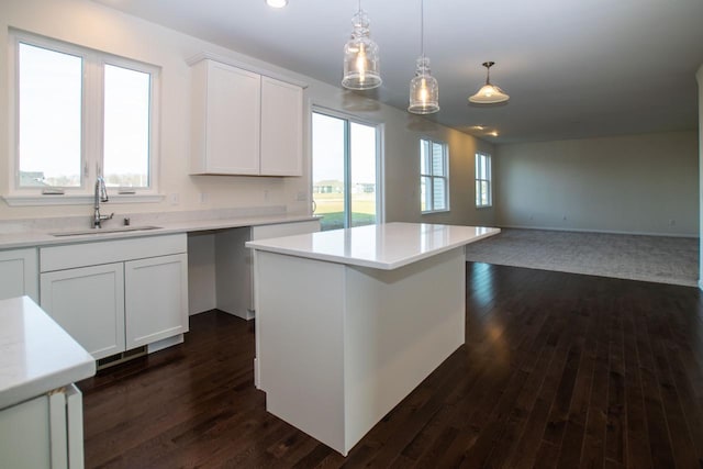 kitchen with a wealth of natural light, light countertops, and a sink