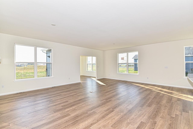 empty room featuring wood finished floors and baseboards